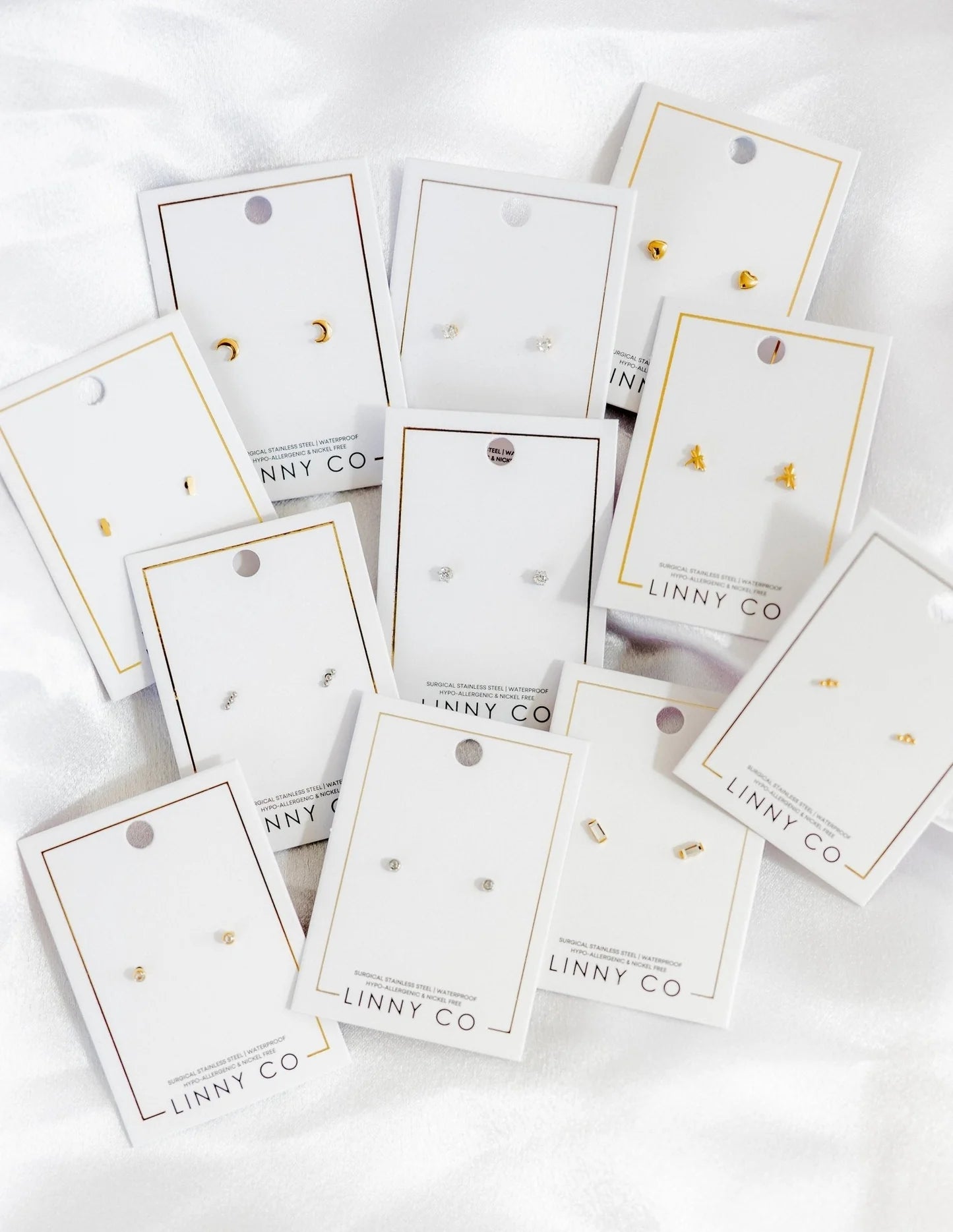 Collection of earring cards with 'LINNY CO' branding on a white background