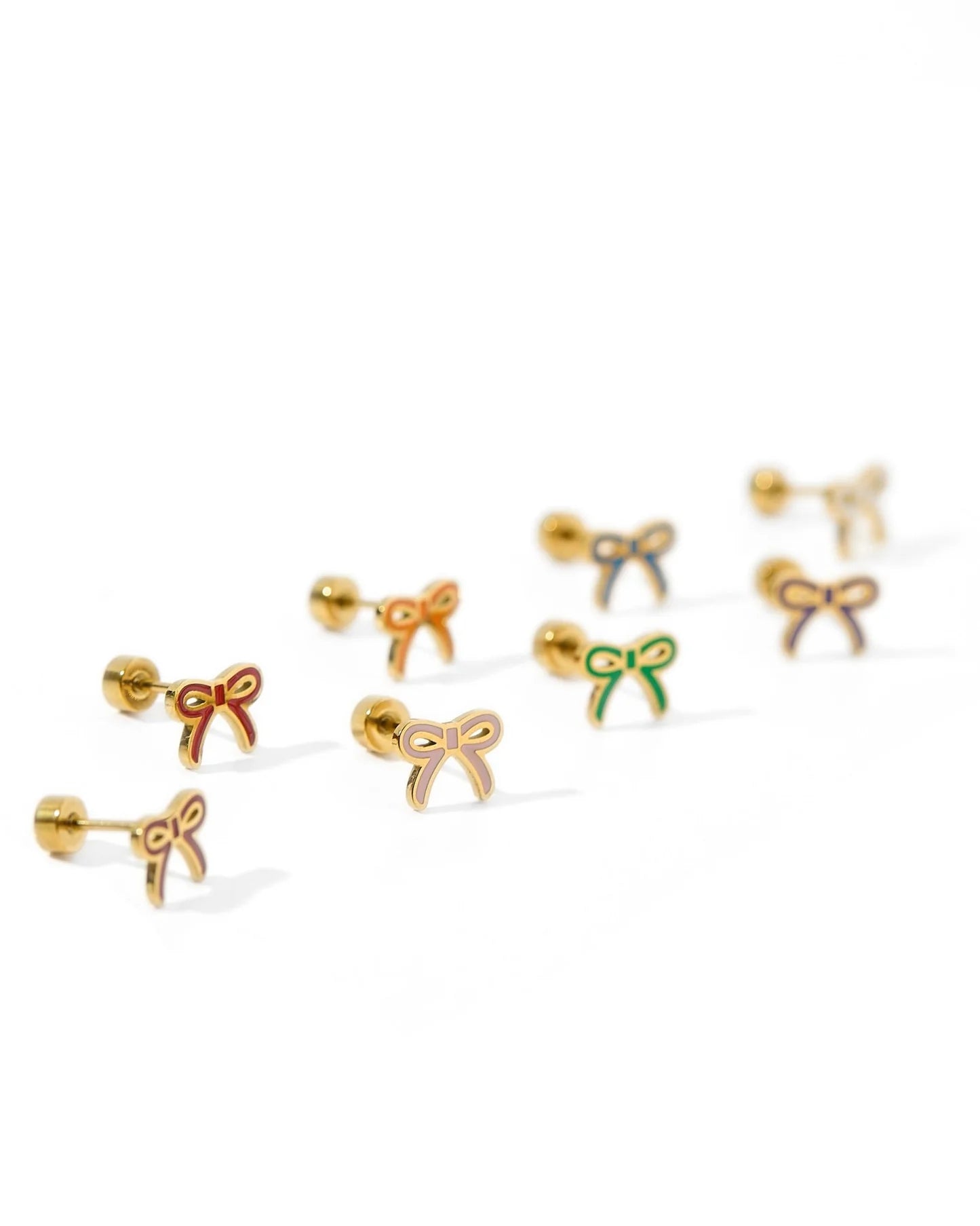 Set of gold bow-shaped earrings on a white background