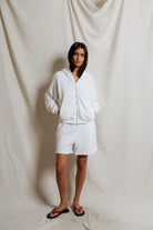 Person wearing a white tracksuit against a plain background