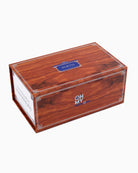 A personalized cigar box with a rich reddish-brown wood grain finish, featuring white decorative corner lines, a blue personalized nameplate reading 'SMITH', and the 'OH MY MY' brand logo on the side, set against a plain white background.