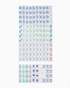 Two sheets of small decorative stickers or stamps displayed on a plain white background. The top sheet contains repeated motifs in blue, green, and pink, while the bottom sheet shows smaller rectangular stickers with text and colorful illustrations.