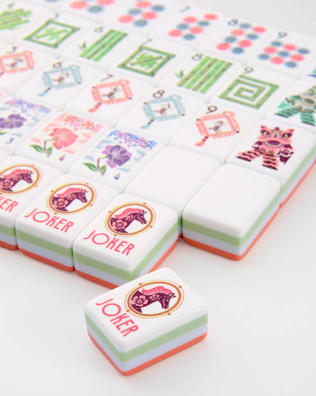 Colorful game pieces with 'Joker' and decorative designs on a white background