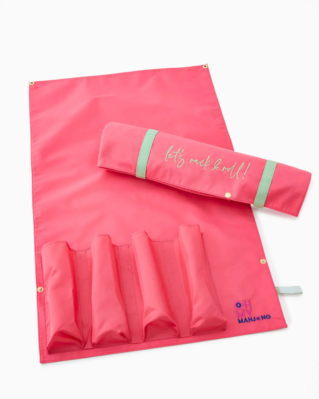 Pink travel mat with rolled-up towel and pouch on a white background