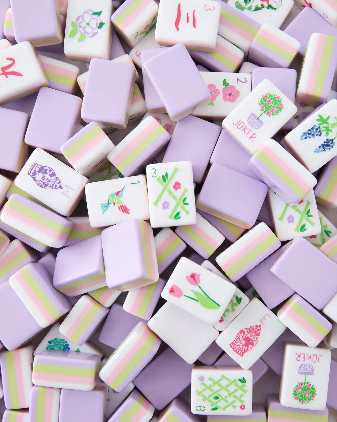 Colorful miniature tiles with various designs on a light purple background
