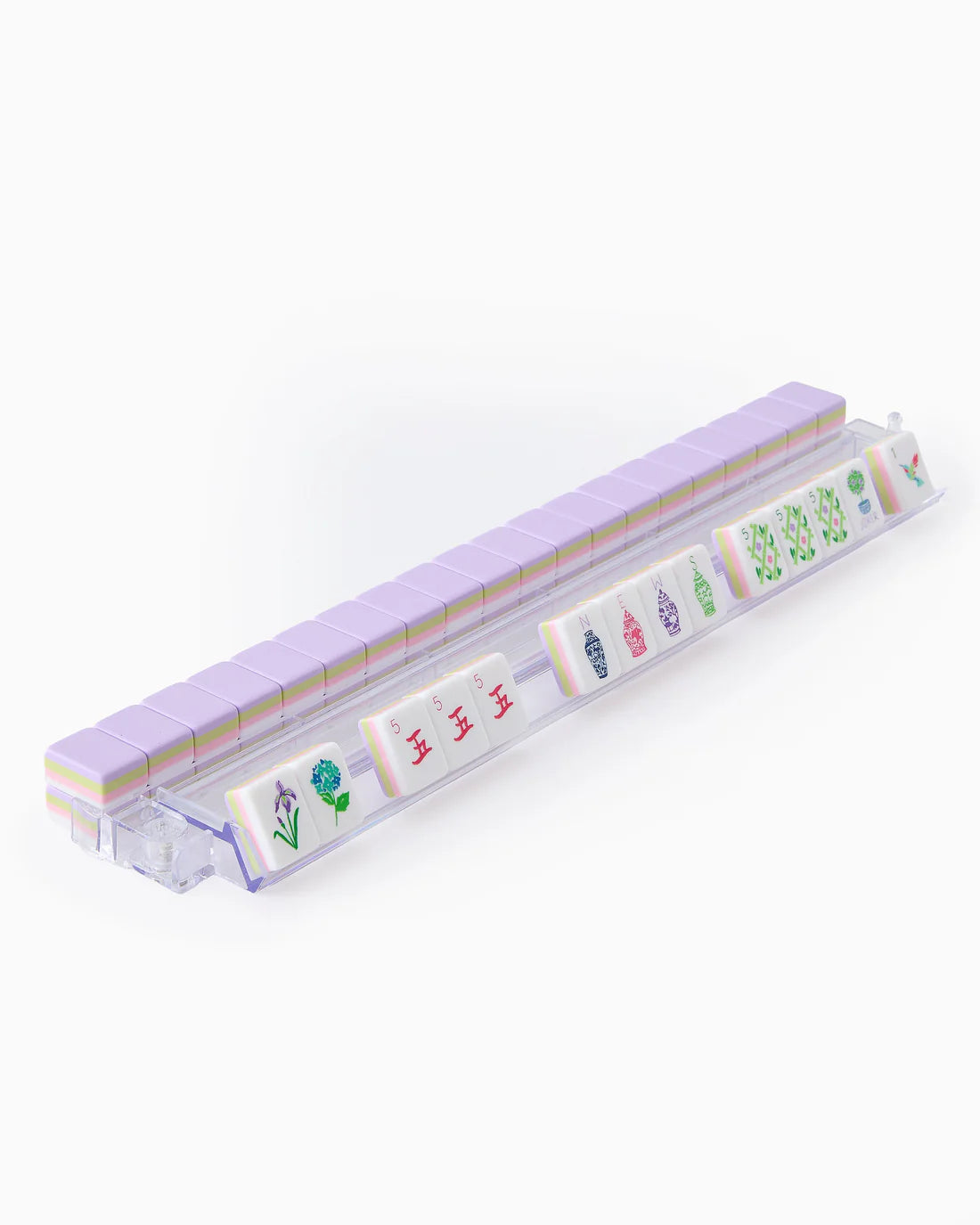 Set of miniature tiles with colorful designs in a clear plastic case on a white background