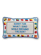 Decorative pillow with nautical flags and text on a white background