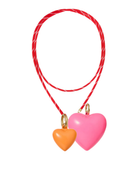 Two heart-shaped charms on a red string with a white background