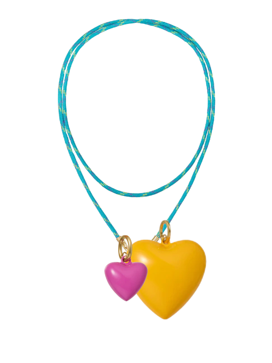 Necklace with two heart-shaped pendants, one pink and one yellow, on a blue cord against a white background.
