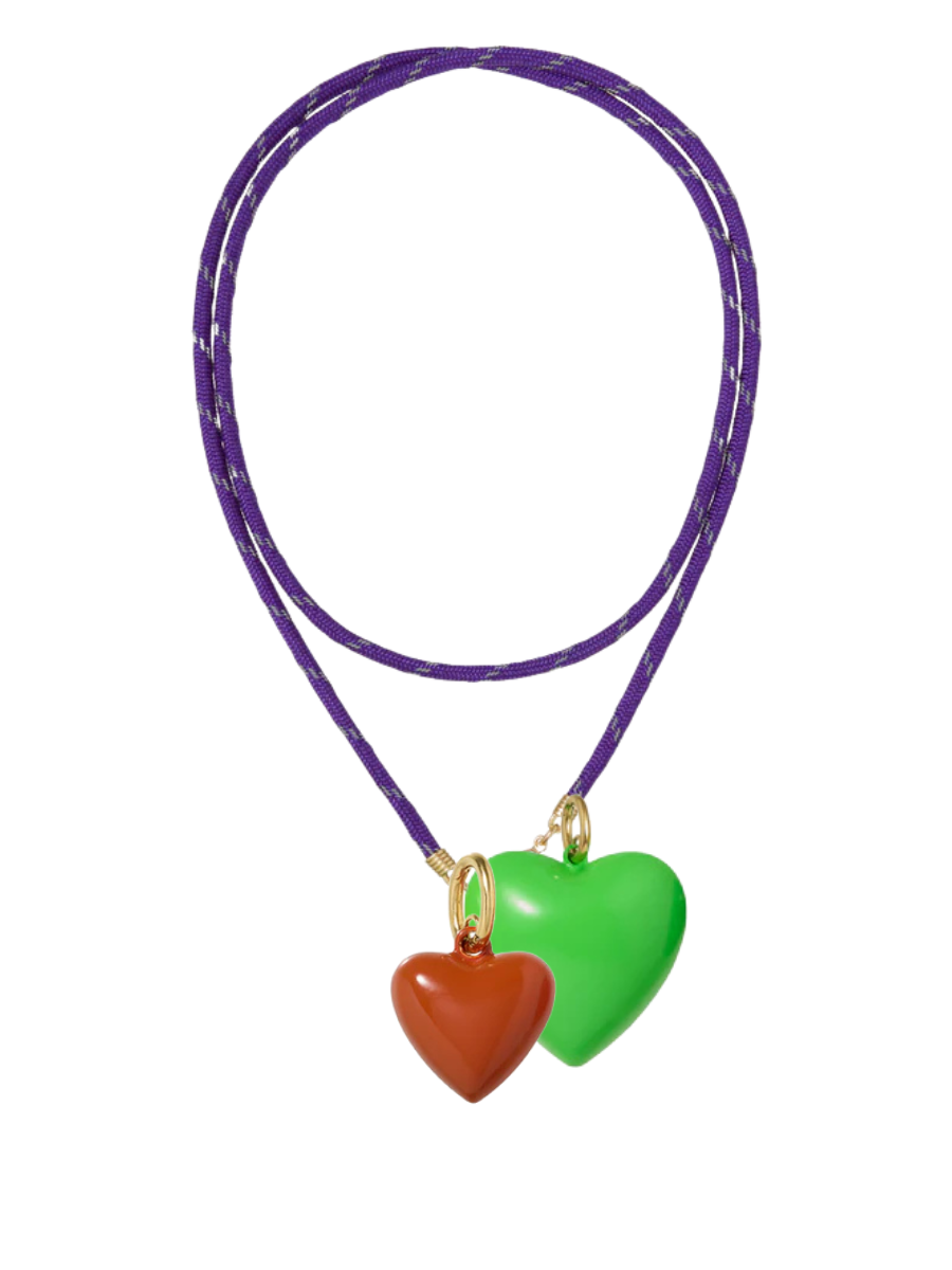 Necklace with two heart-shaped pendants, one red and one green, on a purple cord against a white background.