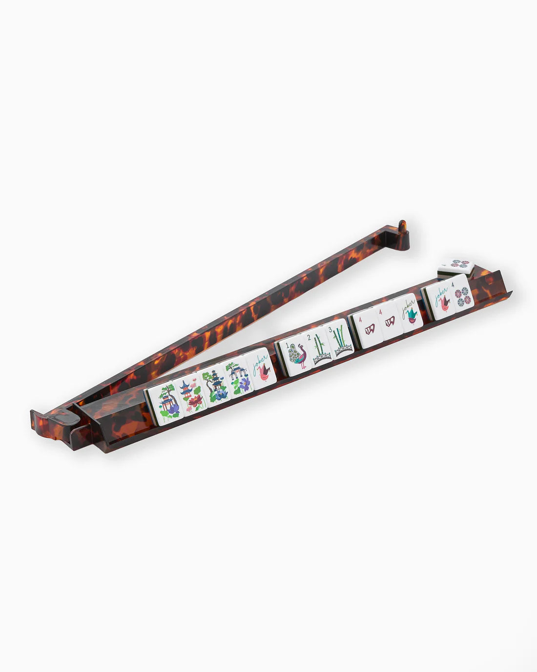 Tortoiseshell case with playing cards inside on a white background