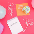 Two cards on a pink background with balloons and a birthday cake.