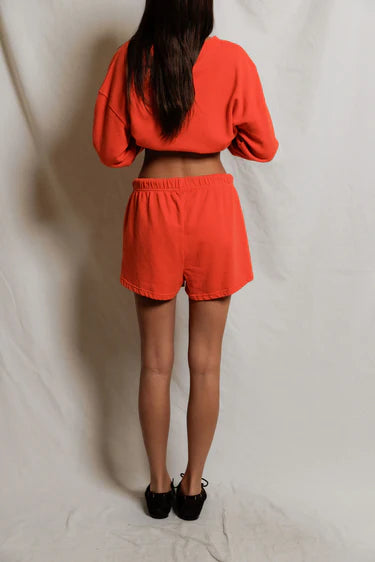 Person wearing a red outfit on a plain background