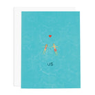 Card with illustration of two people holding hands over water and a heart above them, with 'US' written below on a blue background.