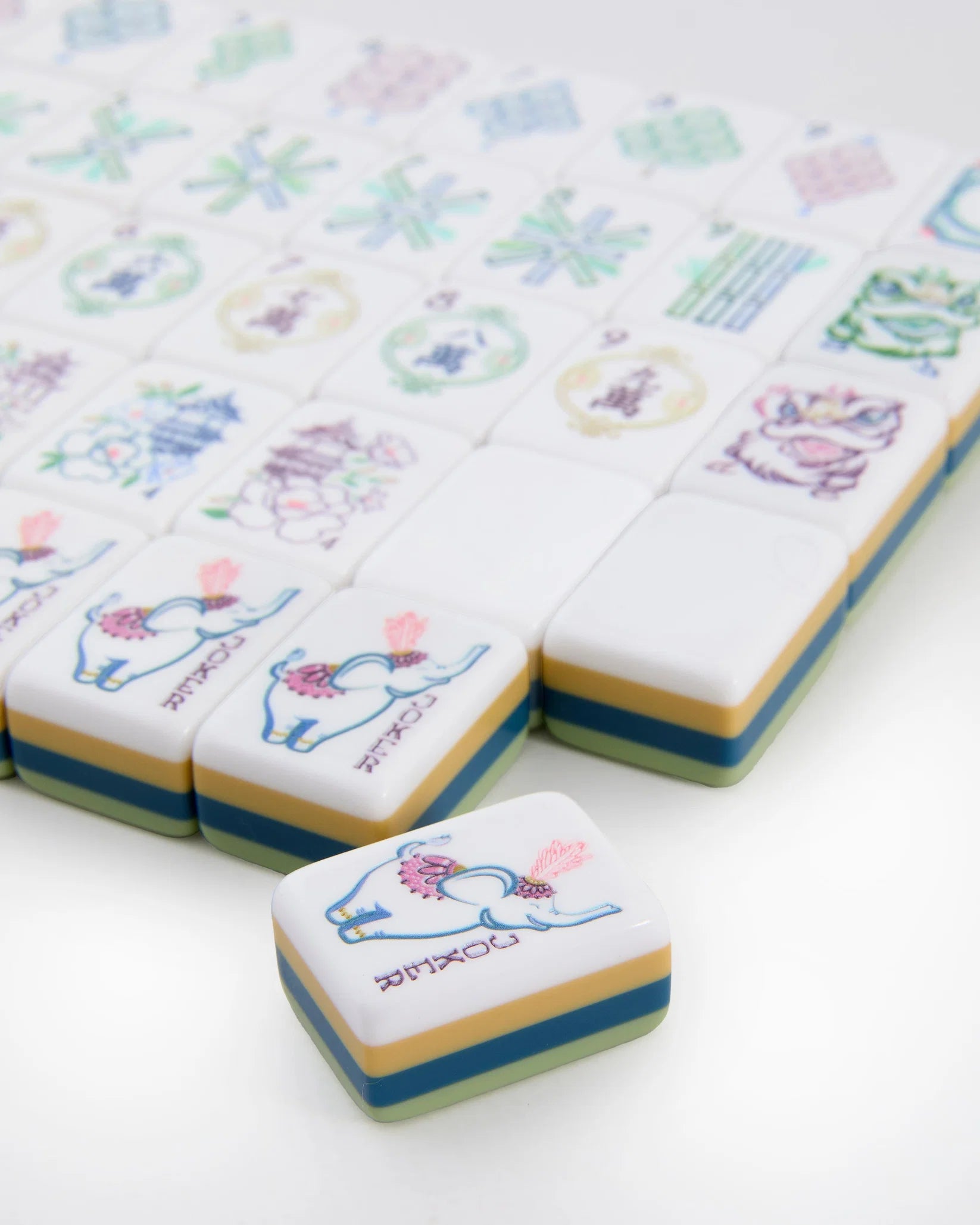 Decorative tiles with cartoon elephant designs on a white background