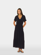 Woman wearing a black dress on a white background