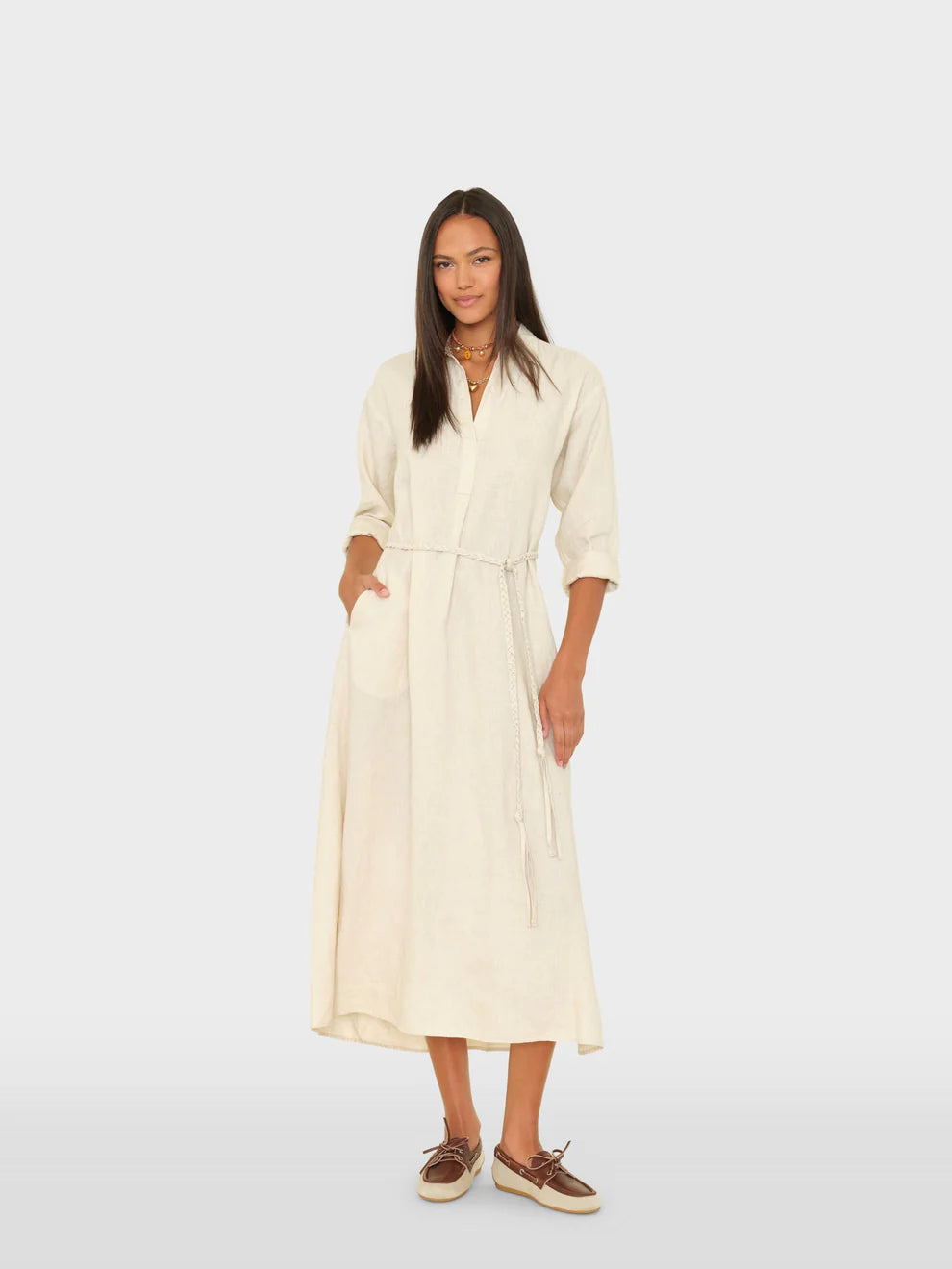 Woman wearing a beige dress on a white background