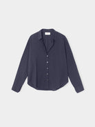 Navy blue shirt on a light gray background