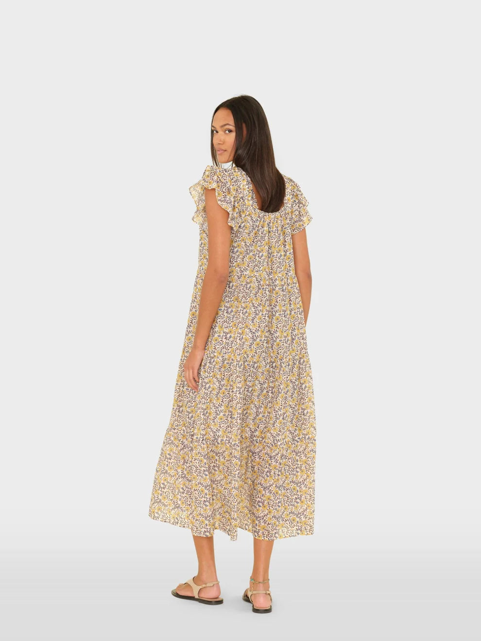 Woman wearing a floral dress on a white background