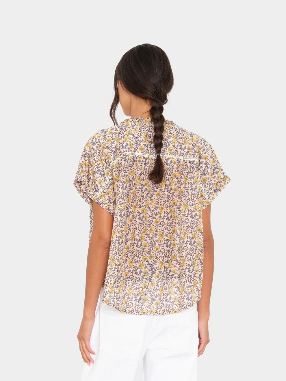 Woman wearing a floral blouse with a white background
