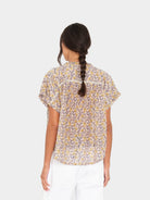 Woman wearing a floral blouse with a white background