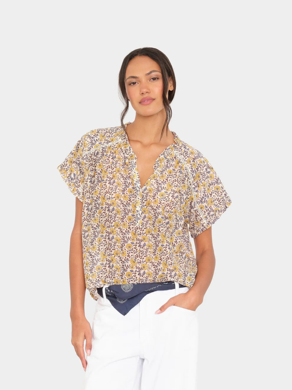 Woman wearing a floral blouse with a plain background