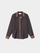 Patterned shirt with brown accents on a light gray background