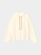 A cream-colored pullover hoodie with a braided tan drawstring, displayed flat against a light gray background.