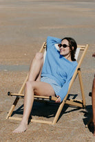 Woman sitting on a beach chair at the beach